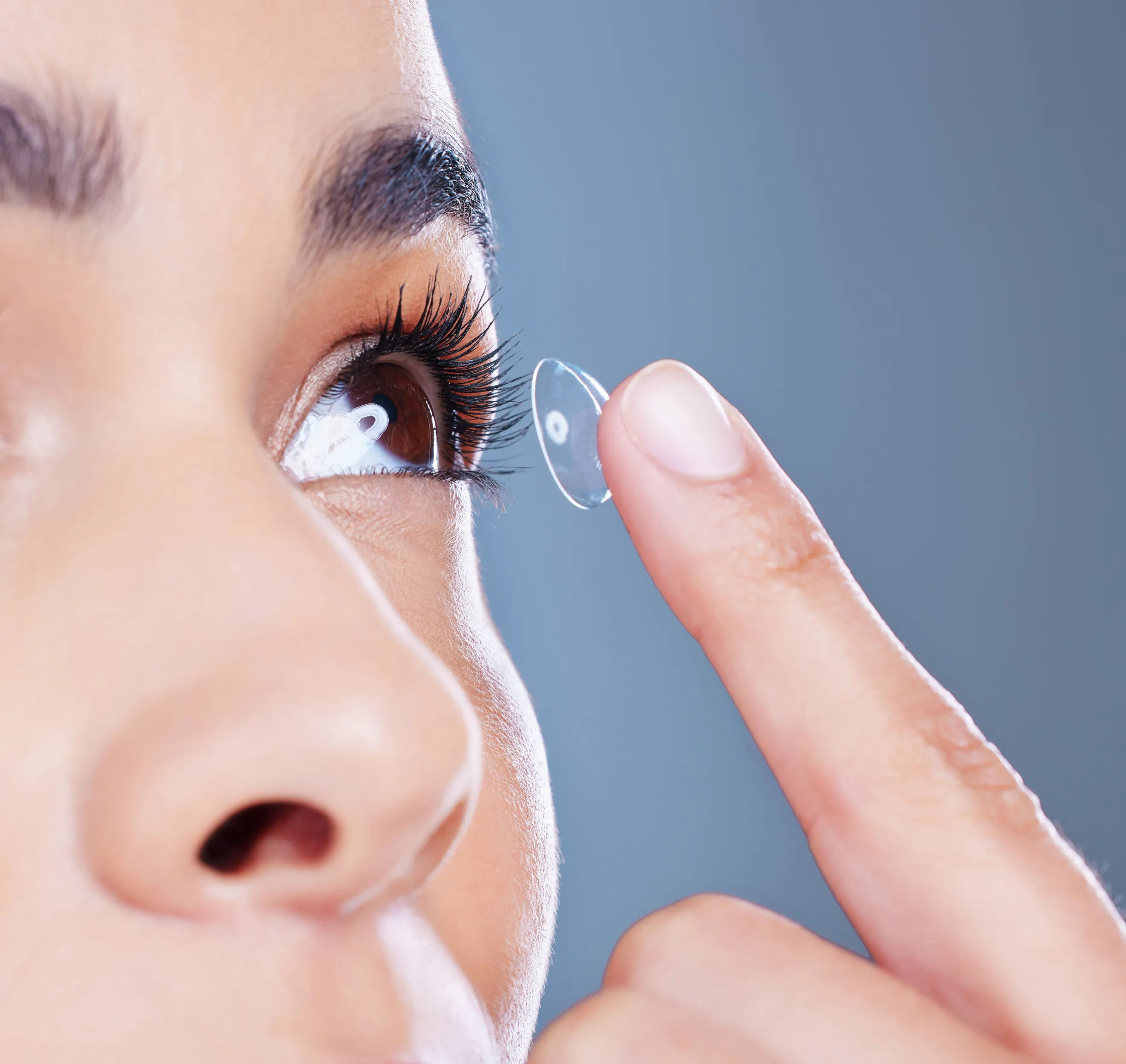 face-woman-eye-care-with-contact-lens-iris-optometry-with-closeup-blue-backgroun.webp